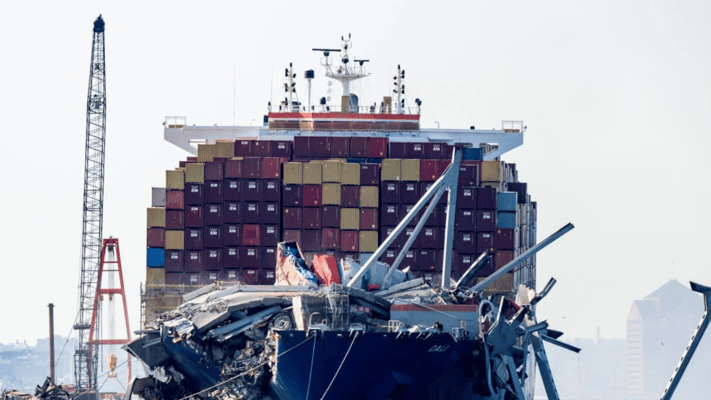 A section of the Francis Scott Key Bridge rests in the water next to the container shop Dali in Baltimore on 13 May, 2024.