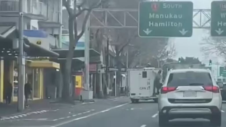 Person caught riding on back of prison van in Central Auckland