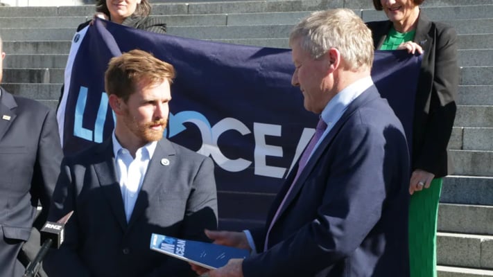 Ultra-marathon swimmer Jono Ridler delivers petition to ban bottom trawling to Parliament