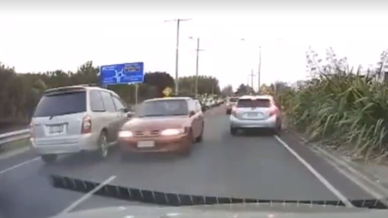 Dashcam&nbsp;footage shows car squeezing between lanes the wrong way